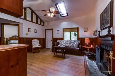 a living room with a couch and a fireplace at Private Cabin Rental with Wood-Burning Fireplace in Canadensis, Pennsylvania in Canadensis