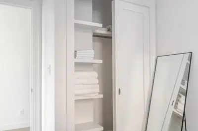 a bathroom with a mirror and white towels at Blueground Bloomingdale fitness center nr Central Park NYC-1869 in New York