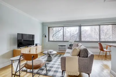 a living room with a couch and a tv at Blueground Manhattan Valley fitness nr Central Park NYC-1101 in New York