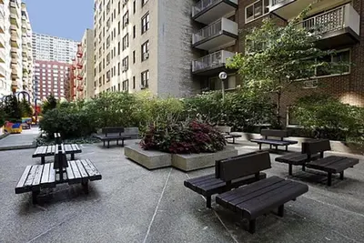 a group of benches in a courtyard with buildings at Blueground Manhattan Valley fitness nr Central Park NYC-1101 in New York