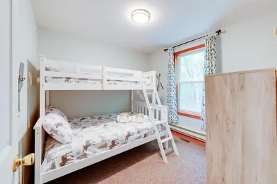 a bedroom with two bunk beds and a window at Game Room and Lake Access Albrightsville Escape in Albrightsville