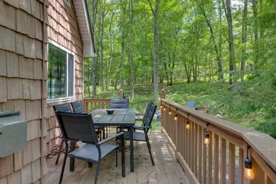 a patio with a table and chairs on a deck at Game Room and Lake Access Albrightsville Escape in Albrightsville