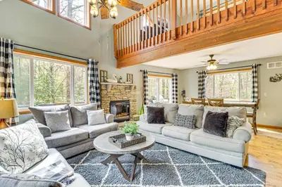 a living room with a couch and a table at Game Room and Lake Access Albrightsville Escape in Albrightsville
