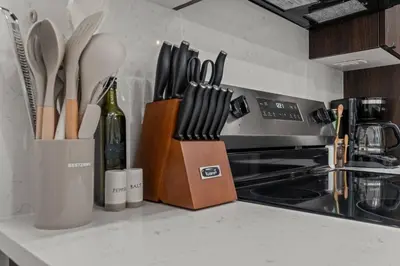 a kitchen counter with knives and a bottle of wine at SLEEP 8 Outdoor Patio-Old City- 2 NEW Townhouses in Philadelphia
