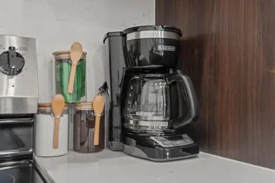 a coffee maker sitting on a counter with wooden spoons at SLEEP 8 Outdoor Patio-Old City- 2 NEW Townhouses in Philadelphia
