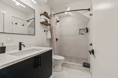 a bathroom with a sink and a toilet and a shower at SLEEP 8 Outdoor Patio-Old City- 2 NEW Townhouses in Philadelphia