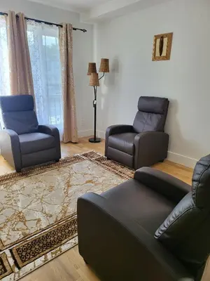 a living room with two chairs and a couch at Tkc Villa in Newark