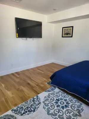 a bedroom with a bed and a flat screen tv at Tkc Villa in Newark