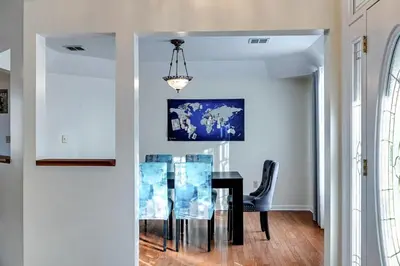 a dining room with a black table and a chandelier at Pocono Home Hot tub Camelback Lake Pool in Albrightsville