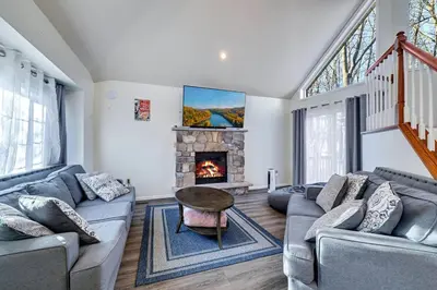 a living room with a couch and a fireplace at Pocono Home Hot tub Camelback Lake Pool in Albrightsville
