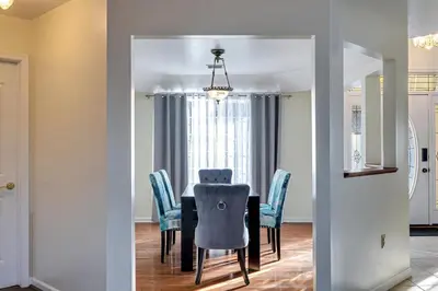 a dining room with a table and blue chairs at Pocono Home Hot tub Camelback Lake Pool in Albrightsville
