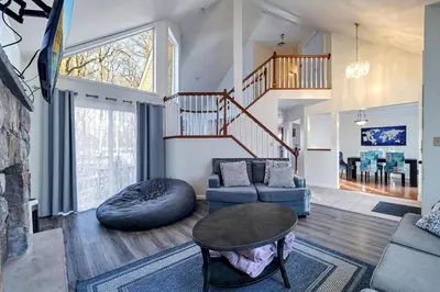 a living room with a couch and a table at Pocono Home Hot tub Camelback Lake Pool in Albrightsville