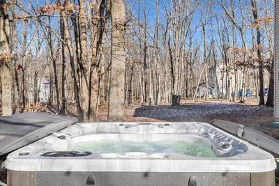 a hot tub in the middle of a forest at Pocono Home Hot tub Camelback Lake Pool in Albrightsville