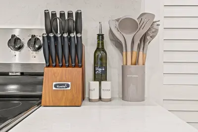 a knife block with a bottle of wine and utensils at Townhouse SLEEP 4 Walk to Liberty Bell |Old City in Philadelphia