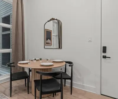 a dining room table with chairs and a mirror at Townhouse SLEEP 4 Walk to Liberty Bell |Old City in Philadelphia
