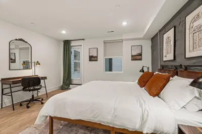 a bedroom with a large white bed and a desk at Townhouse SLEEP 4 Walk to Liberty Bell |Old City in Philadelphia