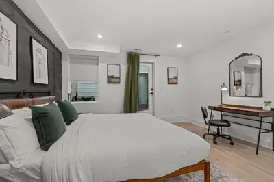 a bedroom with a large bed and a desk at New townhouse SLEEP 4 Best Spot-Old City Philly in Philadelphia