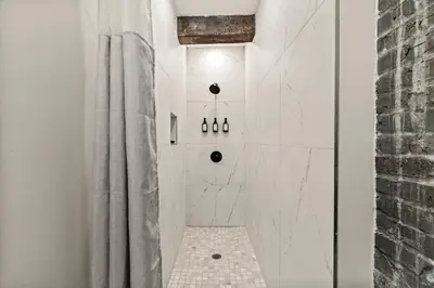 a bathroom with a shower with white walls at SLEEP 4 - Old City Philly - NEW Townhouse in Philadelphia