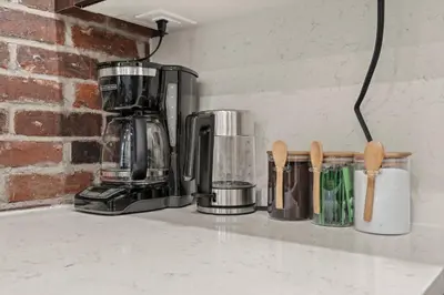 a kitchen counter with a coffee maker and utensils at SLEEP 4 - Old City Philly - NEW Townhouse in Philadelphia