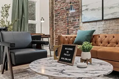 a living room with a couch and a coffee table at SLEEP 4 - Old City Philly - NEW Townhouse in Philadelphia
