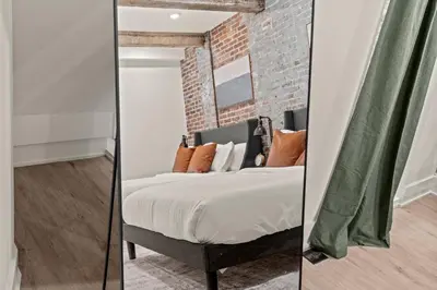 a bedroom with a bed and a brick wall at SLEEP 4 - Old City Philly - NEW Townhouse in Philadelphia