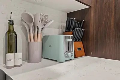 a kitchen counter with a toaster and a bottle of wine at New Townhouse Sleep 4 Old City Walk to Everything! in Philadelphia