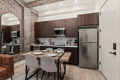 a kitchen with a table and chairs and a refrigerator at New Townhouse Sleep 4 Old City Walk to Everything! in Philadelphia