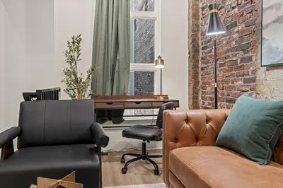 a living room with a couch and a desk at New Townhouse Sleep 4 Old City Walk to Everything! in Philadelphia