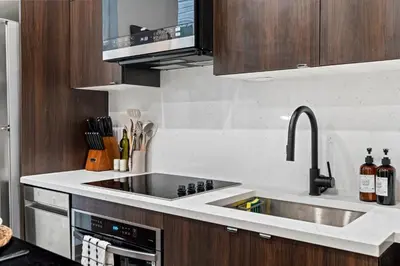 a kitchen with a sink and a stove top oven at Walk to Everything in Old City- ADA compliant unit in Philadelphia