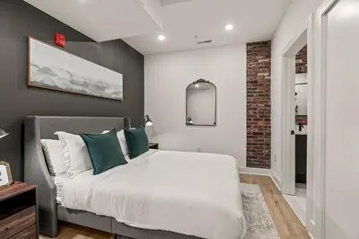 a bedroom with a bed and a brick wall at In The Center of Old City Philly- Walker Paradise! in Philadelphia