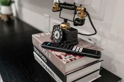 a telephone on top of books with a remote control at In The Center of Old City Philly- Walker Paradise! in Philadelphia
