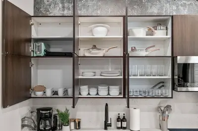 a kitchen cabinet with plates and dishes on it at Sleep 3- Beautiful Unit- Walk Around in Old City in Philadelphia