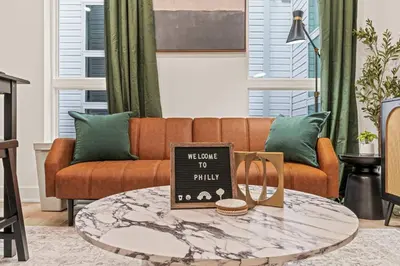 a living room with a couch and a coffee table at Sleep 3- Beautiful Unit- Walk Around in Old City in Philadelphia