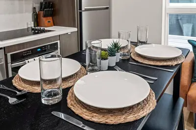 a table with plates and glasses on top of it at Old City-New Building Charm-Walk to Everything! in Philadelphia