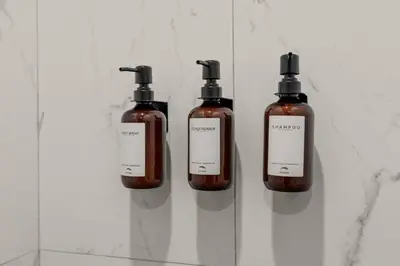 three bottles of soap sitting on a shelf at Old City-New Building Charm-Walk to Everything! in Philadelphia