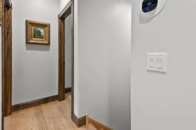 a hallway with a mirror and a door at Long Term Favorite - Skippack Village in Schwenksville