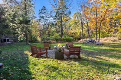 a group of benches in a park with a fire pit at Long Term Favorite - Skippack Village in Schwenksville