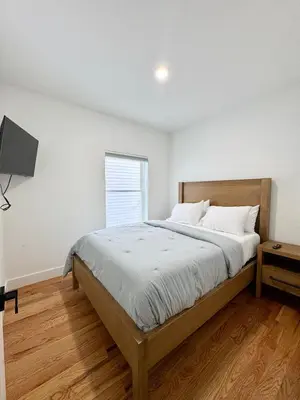 a bedroom with a large bed and a window at Elegant Retreat Near EWR n NYC in Newark