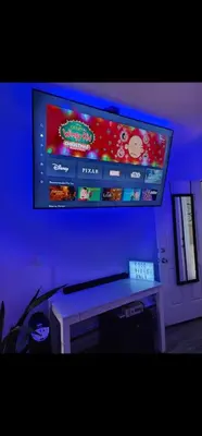 a tv hanging on a wall with a video game screen at The Eternal Oasis in Newark