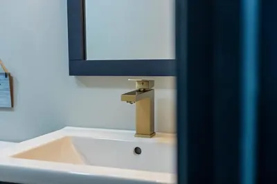 a bathroom sink with a faucet and a mirror at The Blakeslee Blue Escape in Blakeslee