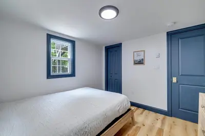a bedroom with a bed and a blue door at The Blakeslee Blue Escape in Blakeslee