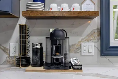 a coffee maker sitting on a wooden shelf at The Blakeslee Blue Escape in Blakeslee