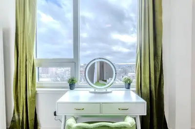 a mirror on a dresser in front of a window at Vibrant Visit 4BR, 4bath, Park 2cars FREE| 20% OFF in East Orange