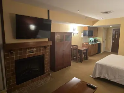 a hotel room with a fireplace with a flat screen tv at The Appalachian Hotel at Mountain Creek Resort - Pool, Hot Tub & Sauna in Vernon Township