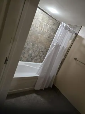 a bathroom with a tub and a shower curtain at The Appalachian Hotel at Mountain Creek Resort - Pool, Hot Tub & Sauna in Vernon Township