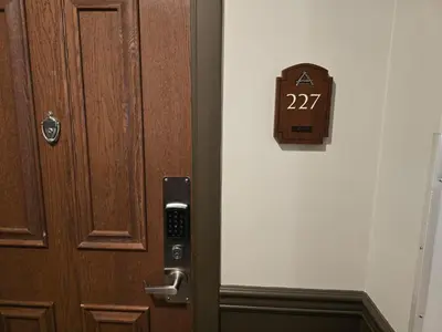 a door with a clock on the wall next to it at The Appalachian Hotel at Mountain Creek Resort - Pool, Hot Tub & Sauna in Vernon Township