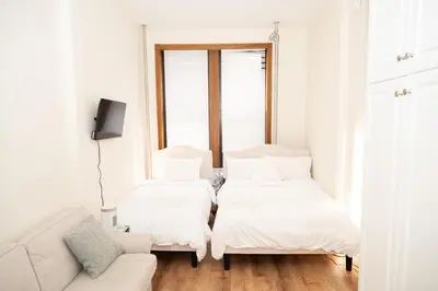 a living room with two beds and a couch at East Village Center Apartment7 w Full Amenities Great New York Location in New York