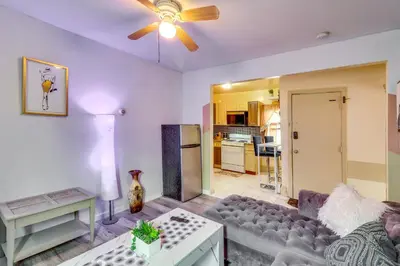 a living room with a couch and a ceiling fan at 3 Mi to Dtwn Newark Eclectic and Walkable Apt! in Newark