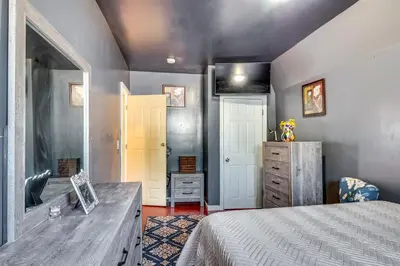 a bedroom with a bed and a dresser at 3 Mi to Dtwn Newark Eclectic and Walkable Apt! in Newark