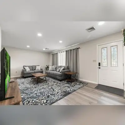 a living room with a couch and a tv at Joyful 5-Bedroom Home in Harrisburg